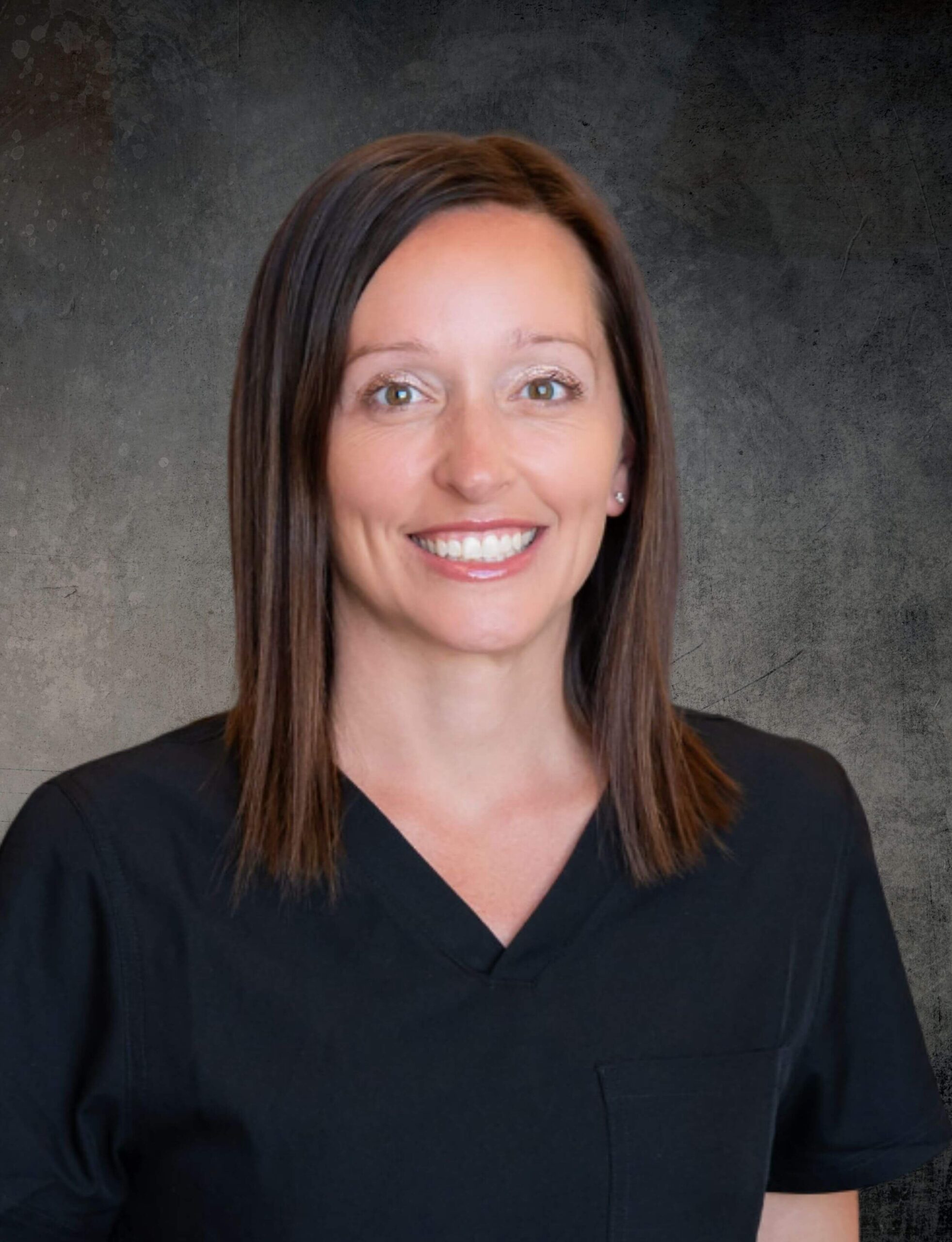 Portrait of Angela D. Liddell, CRNA, ABAAHP, CEO and Functional Wellness Specialist at Accelerate My Wellness, wearing black scrubs and smiling against a neutral background.