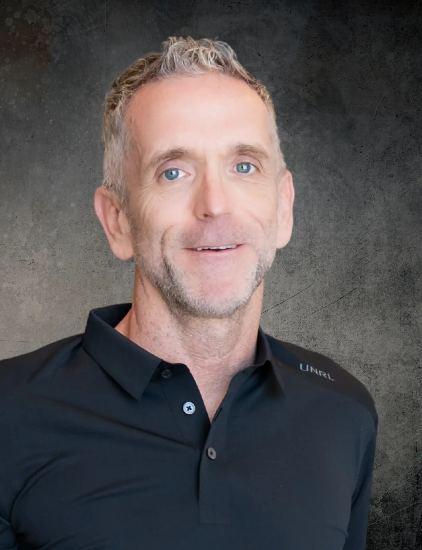 Rich Zieske, PA-C, wearing a black polo shirt, smiling against a light gray background.